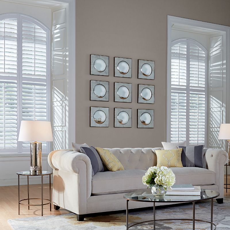 natural wood shutters on tall large shutters in a living room