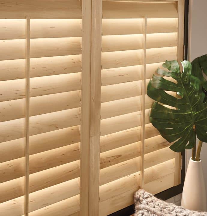 natural wood shutters by a house plant